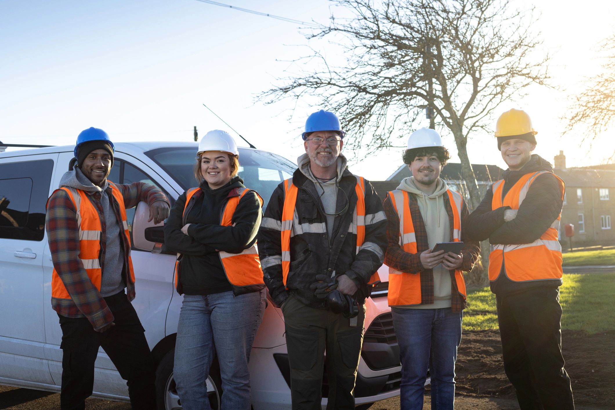 Service crew standing together near a work van