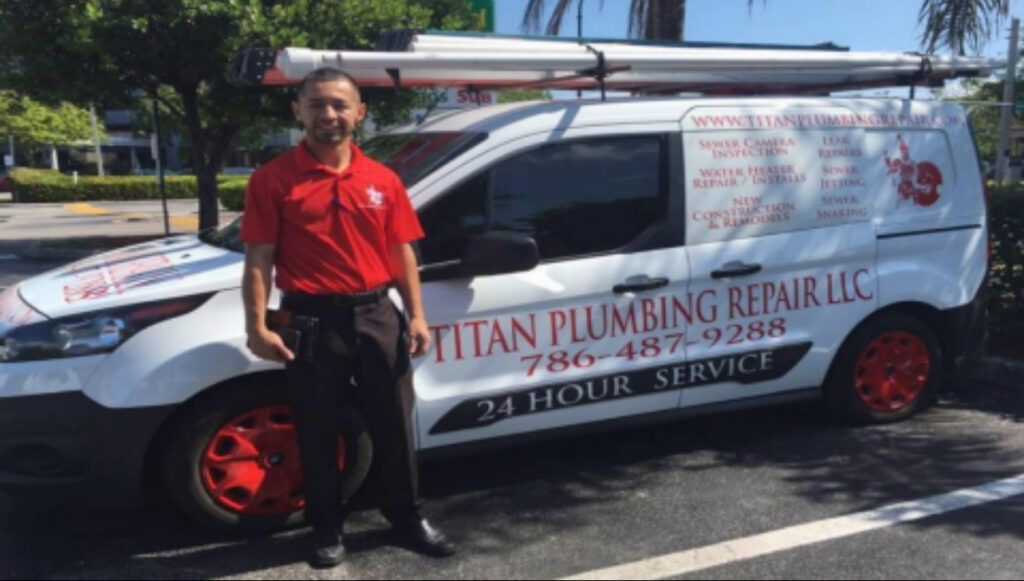 Titan Plumbing Repair technician standing in front of a branded white service van